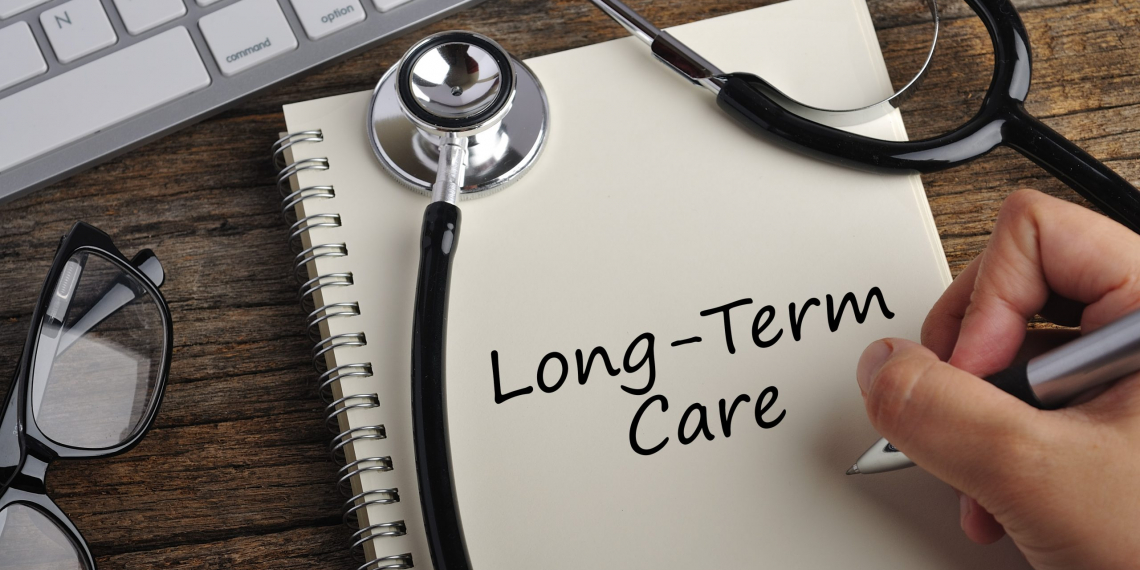 Women Hand Write "LONG-TERM CARE" On Note Book