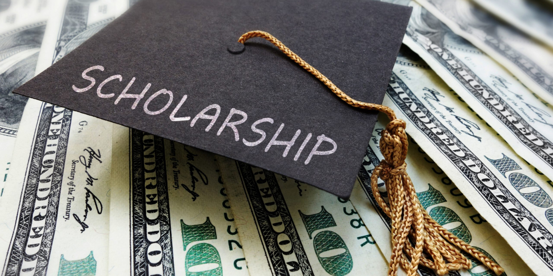 Scholarship graduation cap on money