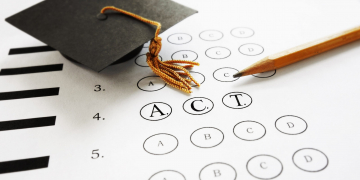 ACT college entrance test with pencil and  graduation cap